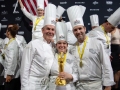 L-RT.Keller-S.DePalma-M.Peters-with-statue-TeamUSA_NOLA-576-photocredit_KenGoodman