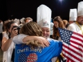 Stefani-hugging-Pati-with-Tim-Hollingsworth-on-sideTeamUSA_NOLA-561-photocredit_KenGoodman