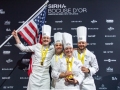 Team-USA-on-podium-with-flag-statue-TeamUSA_NOLA-545-photocredit_KenGoodman